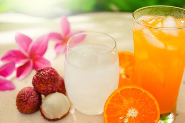 Glas-Litschi-Saft auf Sand-Hintergrund