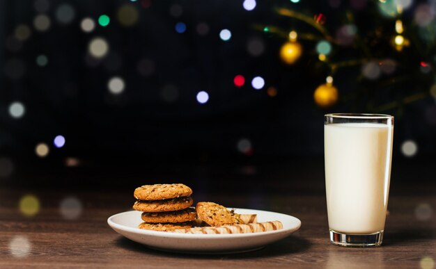 Glas Milch und Weihnachtsfestlichkeiten auf einer Platte