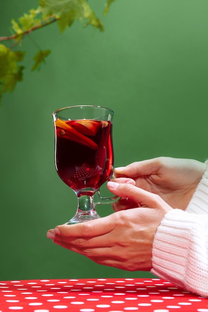 Glas mit köstlichem aromatischem Cocktail-Glühwein mit Orangenscheibe und Zimtstange isoliert