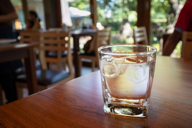 Glas Wasser auf Holztisch im Restaurant