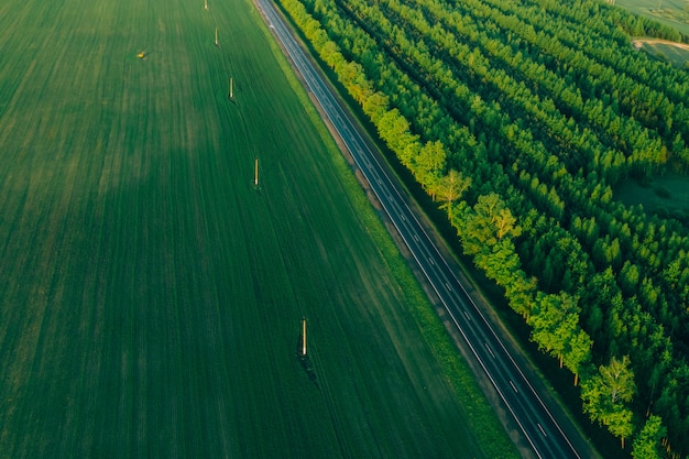 Glatte Autobahn zwischen Feld und Wald. Drohnenansicht