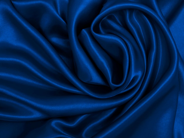 Glatte, elegante blaue Seide oder Satin-Luxus-Tuch-Textur als abstrakter Hintergrund