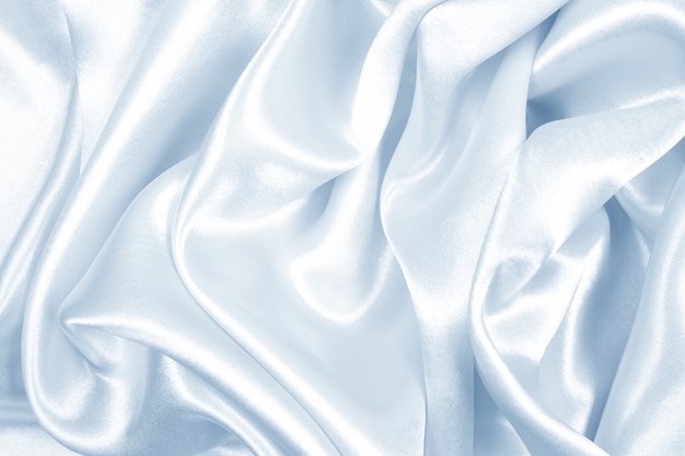 Glatte elegante blaue Seiden- oder Satinbeschaffenheit kann als abstrakter Hintergrund, Gewebe verwenden