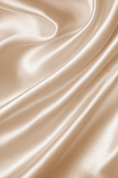 Glatte, elegante goldene Seide als Hochzeitshintergrund im sepiafarbenen Retro-Stil