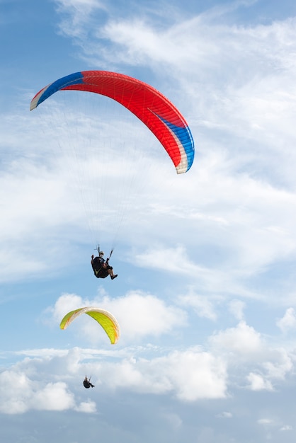 Gleitschirmfliegen am blauen Himmel