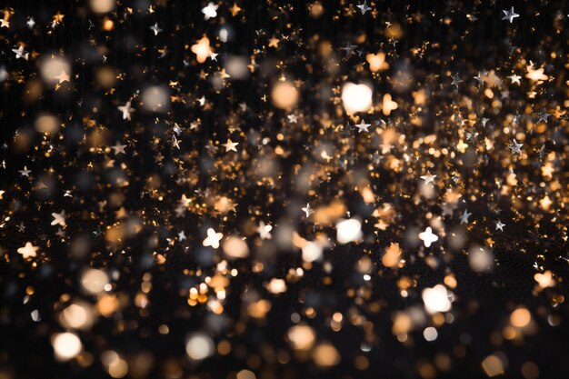 Glitter-Vintage-Lichter Hintergrund gold und schwarz verfocust