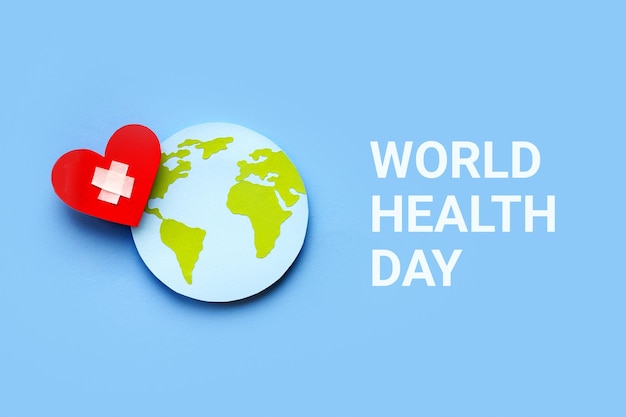 Globo de papel do conceito do dia mundial da saúde e coração vermelho sobre fundo azul