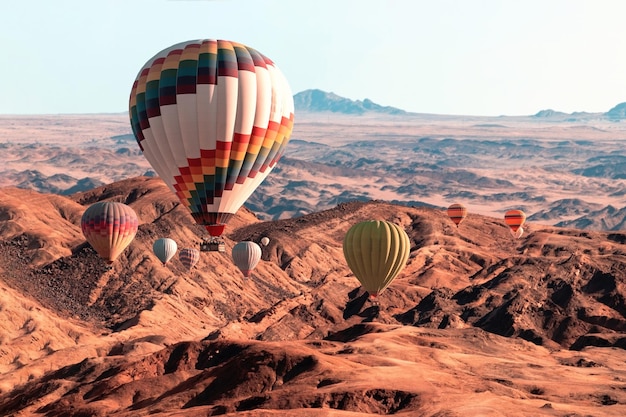 Globos de colores volando sobre la montaña del valle de la luna África Namibia