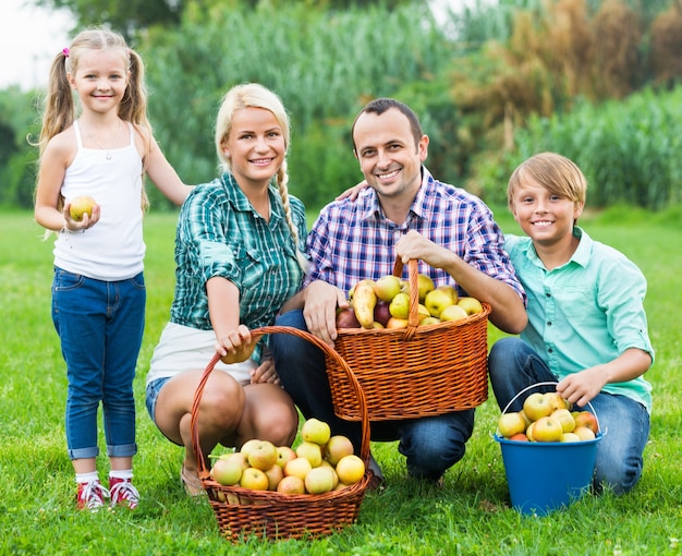 Glückliche Eltern und Kinder mit Äpfeln