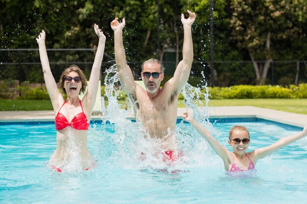 Glückliche Eltern und Tochter, die Spaß im Pool haben