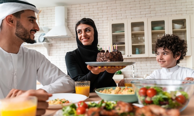 Glückliche Familie aus den arabischen Vereinigten Emiraten, die zusammen essen und die Nationalfeiertage feiern