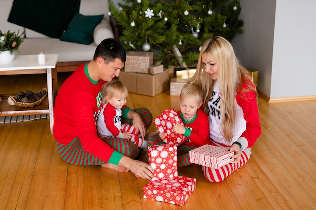 glückliche Familie, die Geschenke zu Hause auspackt