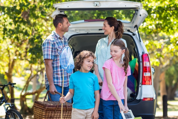 Glückliche Familie, die zu Autoreise fertig wird