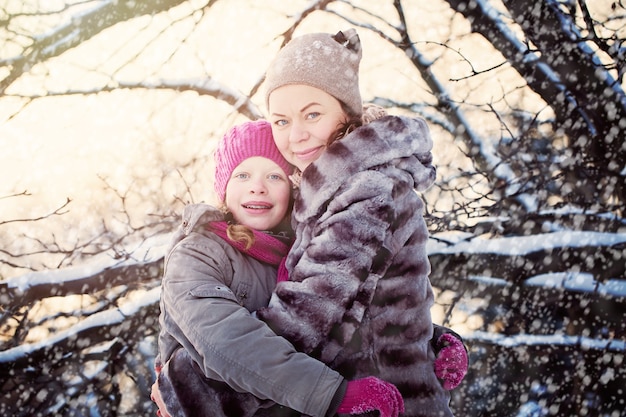 Glückliche Familie im Winterpark. Glückliche Mutter mit Tochter