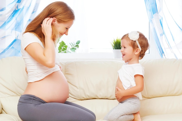 Glückliche Familie Schwangere Mutter und Tochter haben Spaß beim Entspannen und Spielen auf dem Sofa zu Hause