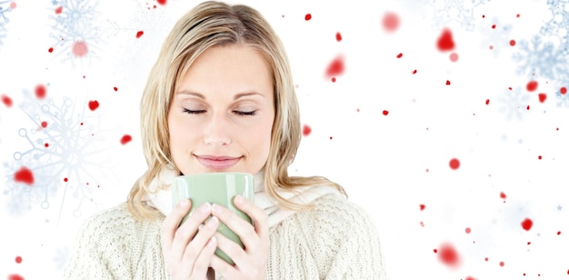 Glückliche Frau, die einen heißen Kaffee genießt, der gegen Schneeflockenmuster steht