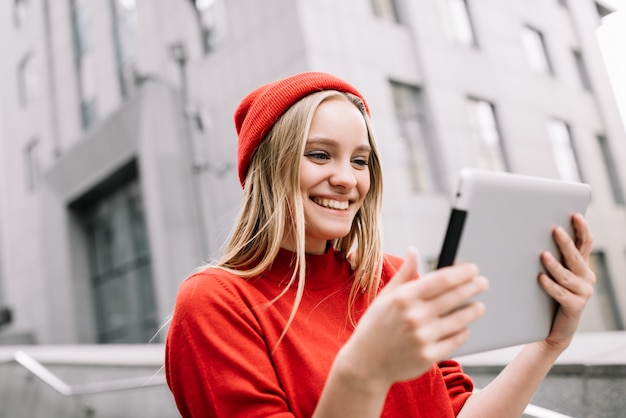 Glückliche Frau, die Film hält Tablet-Computer hält. Schönes positives Blogger-Streaming-Video online