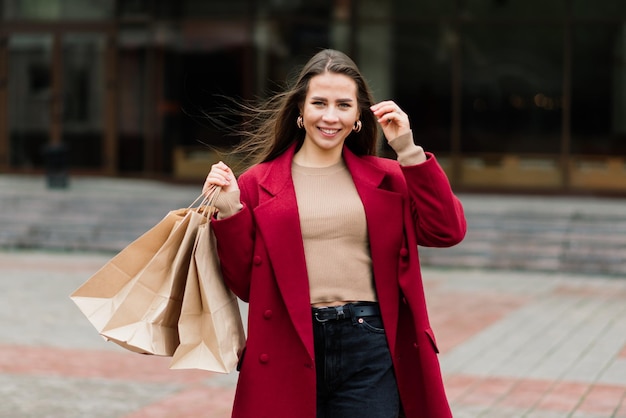 Glückliche Frau mit Einkaufstüten, die das Einkaufen genießen Konsumismus-Lifestyle-Konzept
