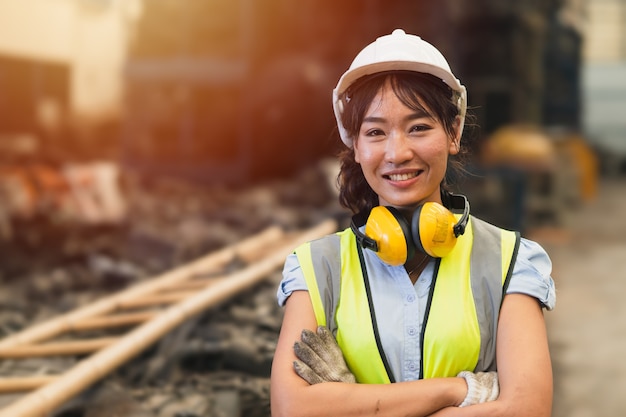 Glückliche Frauen Ingenieur asiatische Arbeiter weibliche Arbeit in Fabrik Porträt Lächeln stehend Arm falten Vertrauen Look