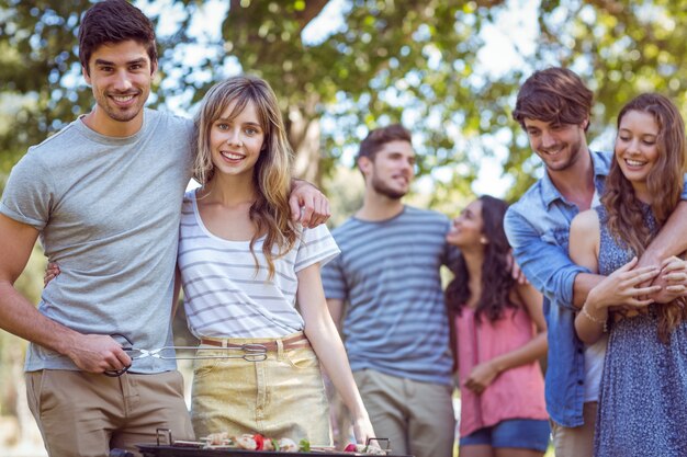 Glückliche Freunde im Park, der Grill hat