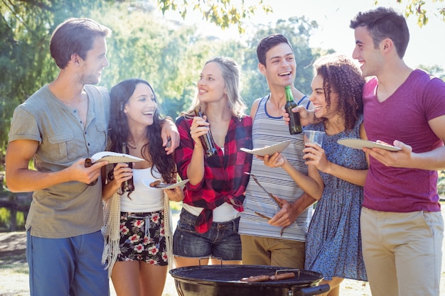 Glückliche Freunde im Park, der Grill hat