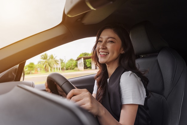 Glückliche junge Frau im Auto