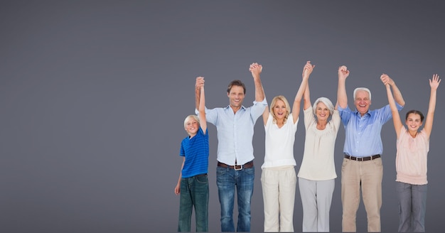 Glückliche kaukasische Familie mit drei Generationen, die Händchen in der Luft mit Kopienraum auf grauem Hintergrund hält