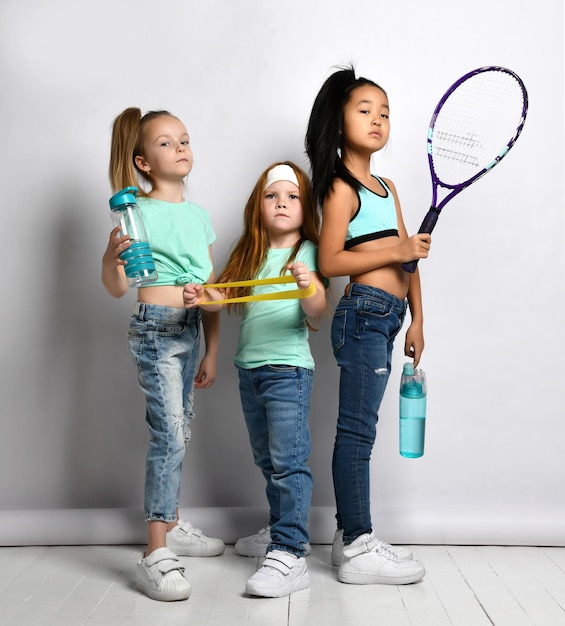 Foto glückliche kinder mit sportausrüstung im studio aufgenommenes porträt