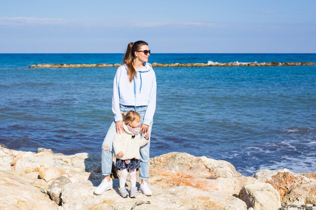 Glückliche Mutter und kleine Tochter am Strand