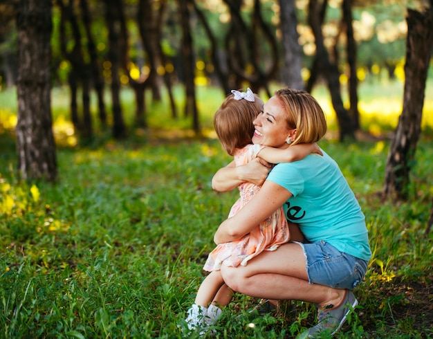 Glückliche Mutter und Tochter, die Natur anlächeln.