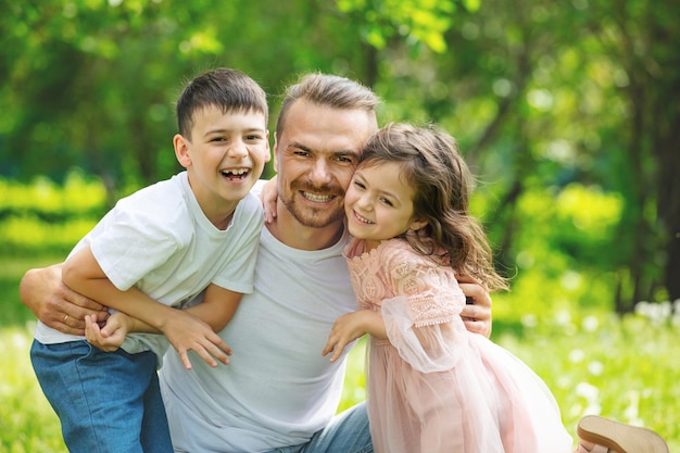 Glückliche schöne Familie zusammen Vater Sohn und Tochter Porträt auf einem Spaziergang an einem sonnigen Sommertag