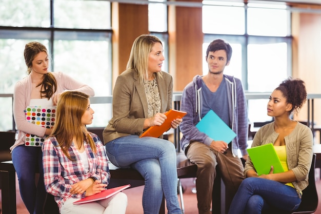 Glückliche Studenten, die mit ihrem Lehrer sprechen