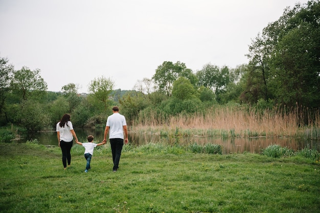 Glücklicher Familienmuttervater und -kindsohn auf Natur am Sonnenuntergang.