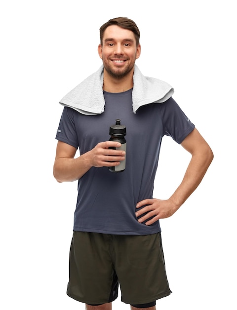 glücklicher Mann in Sportkleidung mit Flasche und Handtuch
