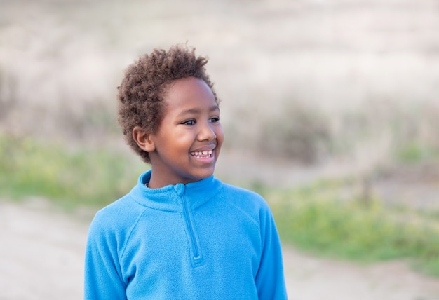 Glückliches afrikanisches Kind mit blauem Trikot