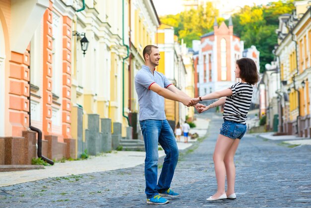 Glückliches junges Paar in der Liebe, die an Stadt umarmt