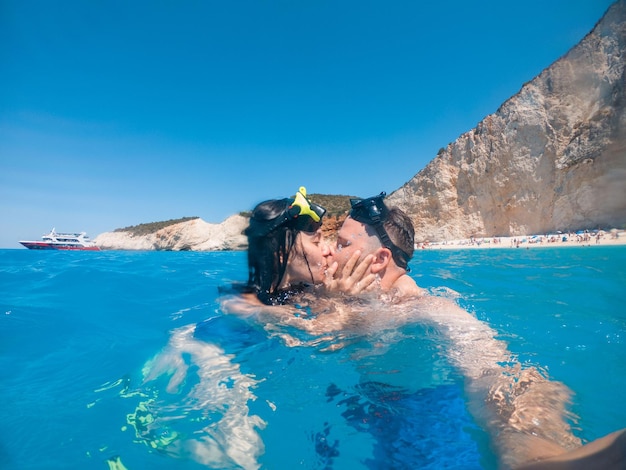 Glückliches Paar, das unter Wasser in einer Tauchermaske schwimmt