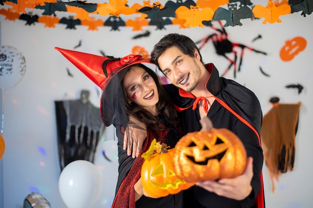 Glückliches Paar der Liebe in Kostümen und Make-up auf einer Feier von Halloween