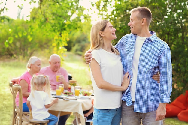 Glückliches Paar mit Familie mit Grillparty im Freien