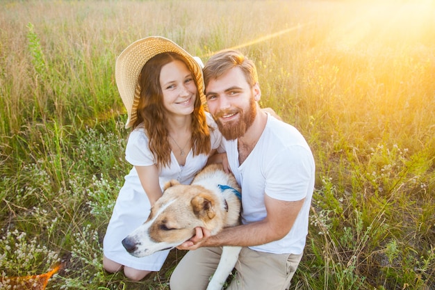 Glückliches schönes Paar mit ihrem Alabai-Hund