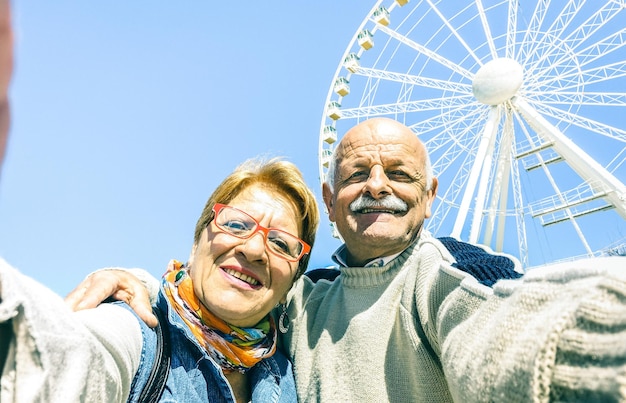 Glückliches Seniorenpaar im Ruhestand, das bei Winterreisen um die Welt Selfie macht