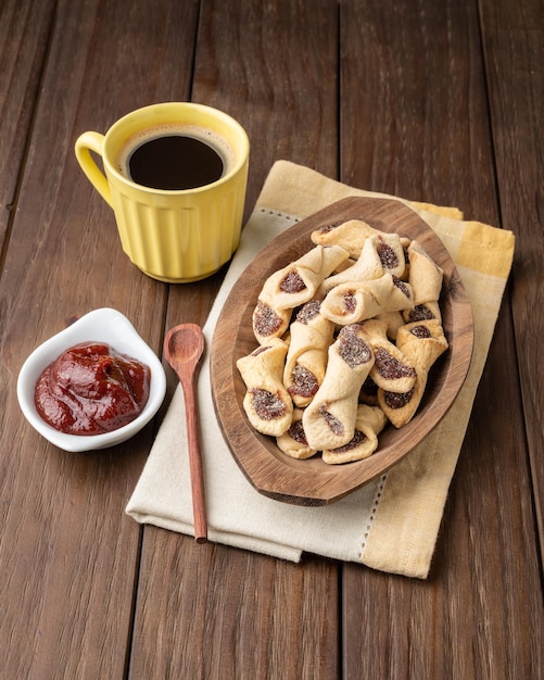 Goiabinha ou beliscao biscoito recheado de goiaba caseiro tradicional brasileiro com café sobre mesa de madeira