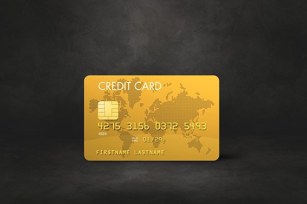 Gold-Kreditkartenschablone auf einem schwarzen Beton.