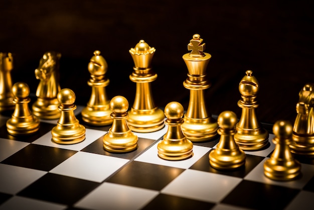 Gold Schachfiguren auf einem Schachbrett