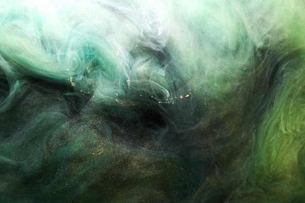 Golden funkelnder abstrakter Hintergrund Luxus grüner Rauch Acrylfarbe Unterwasserexplosion kosmische wirbelnde Tinte