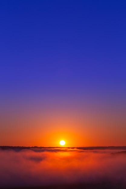 Goldenblue verão nascer do sol sobre nevoeiro sem nuvens em composição minimalista