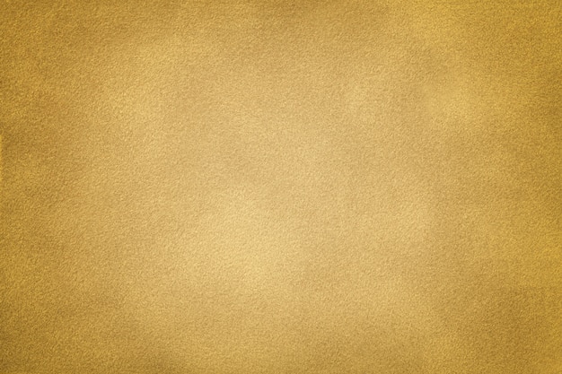 Goldene matte Veloursledergewebenahaufnahme. Velvet Textur Hintergrund