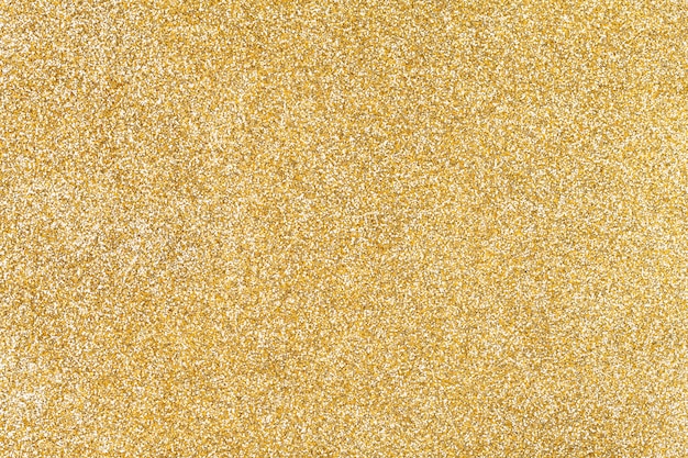 Goldener funkelnder Hintergrund von den kleinen Pailletten,