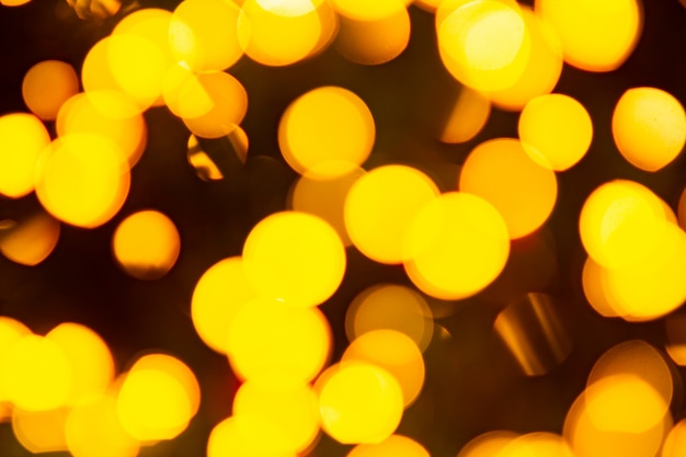 Goldener gelber abstrakter Hintergrund mit defokussierten unscharfen Bokeh-Lichtern
