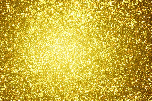 Goldener Glitzerpulverstaub, der Hintergrund platzt